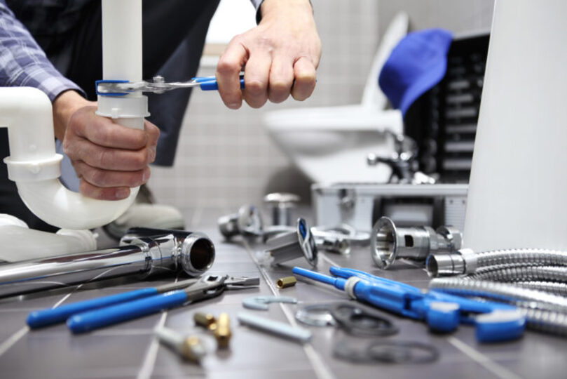 Plumber repairing pipes