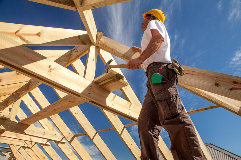 Construction worker building a roof