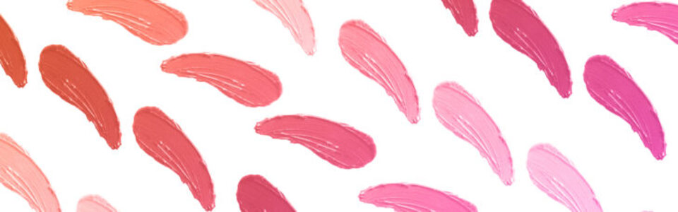 A variety of pinkish lipstick swatches on a white background