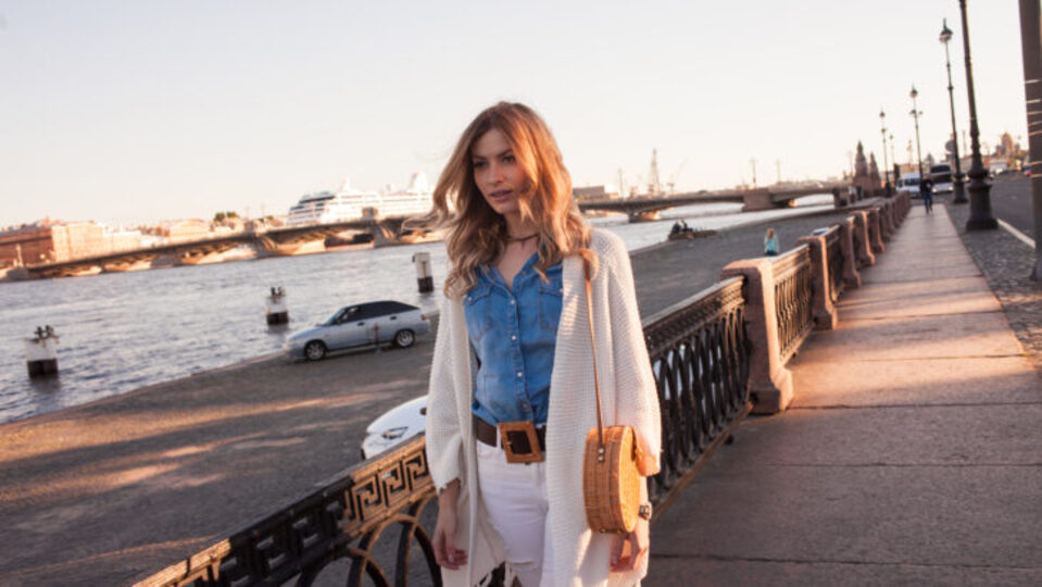 Woman on a boardwalk wearing a cardigan