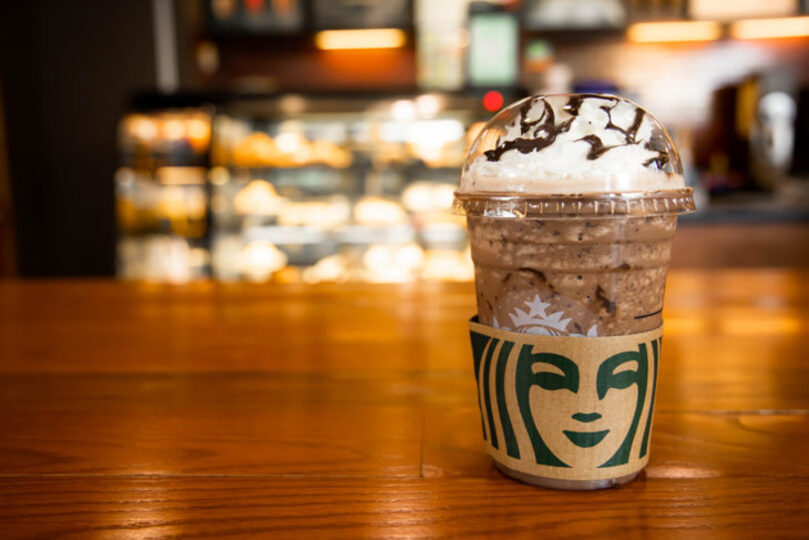 Mocha Cookie Crumble Frapp drink from Starbucks sitting on a table in a Starbucks