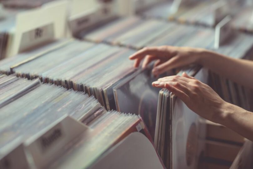 Person pawing through a selection of vinyl records 