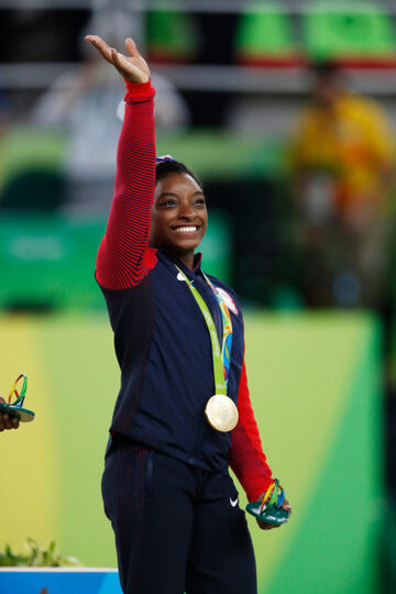 Shot of Simone Biles smiling and waving