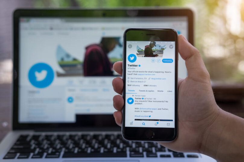 A phone and a computer that both have Twitter open