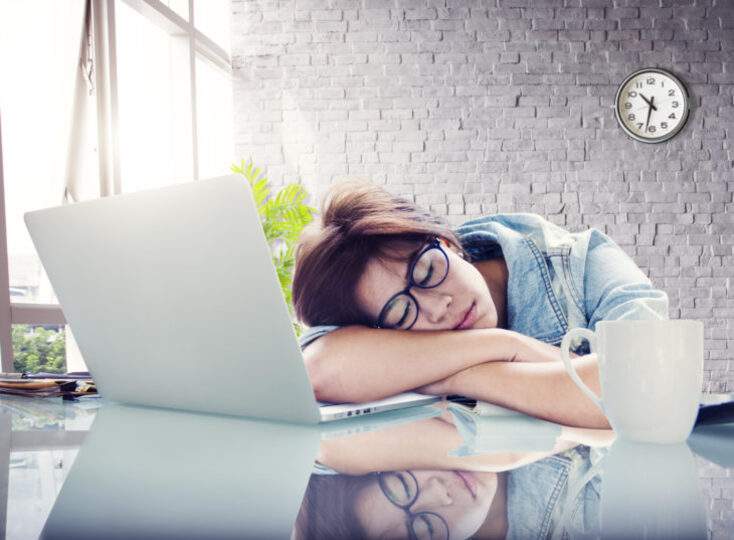 Woman taking a nap on her desk