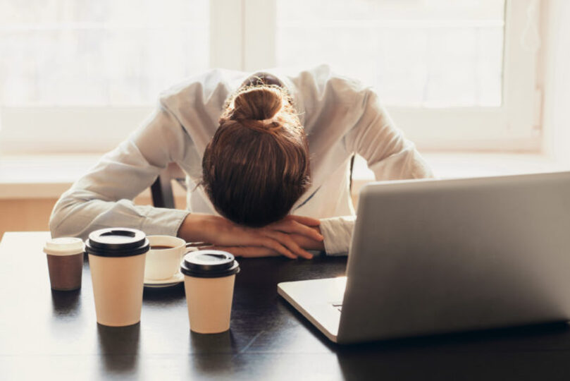 Woman with her head on the desk