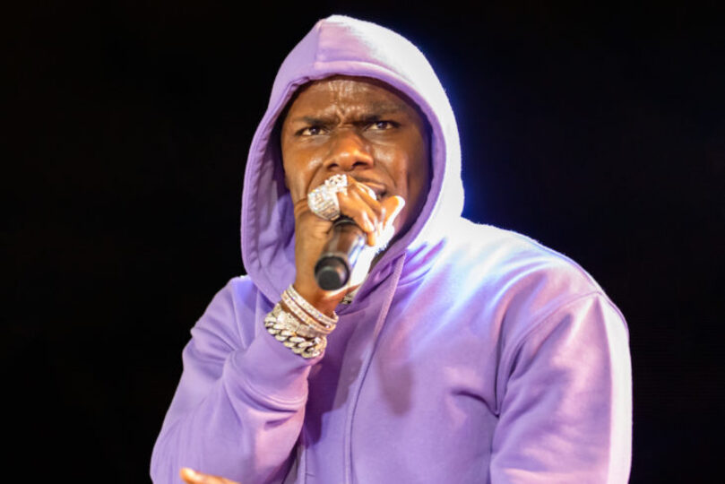 Dababy performing with a microphone 