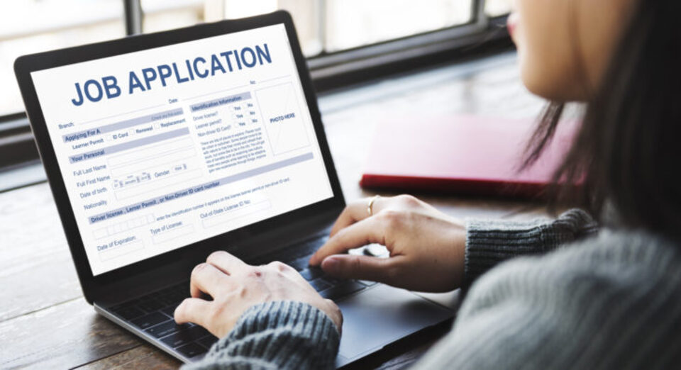 Someone filling out a job application on their laptop