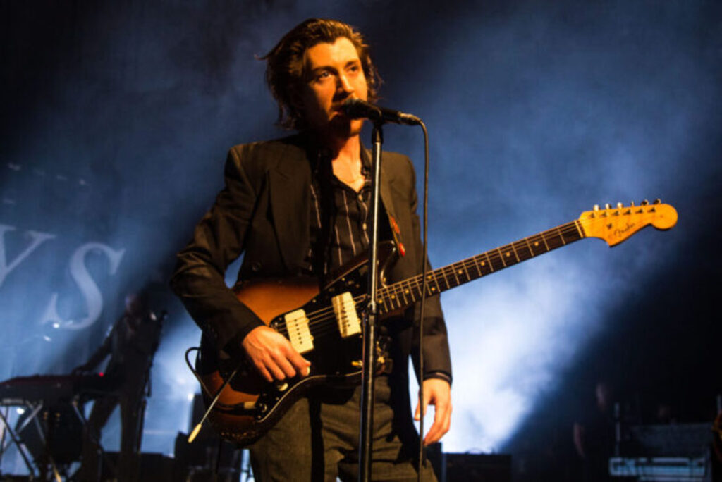 Alex turner talking on microphone