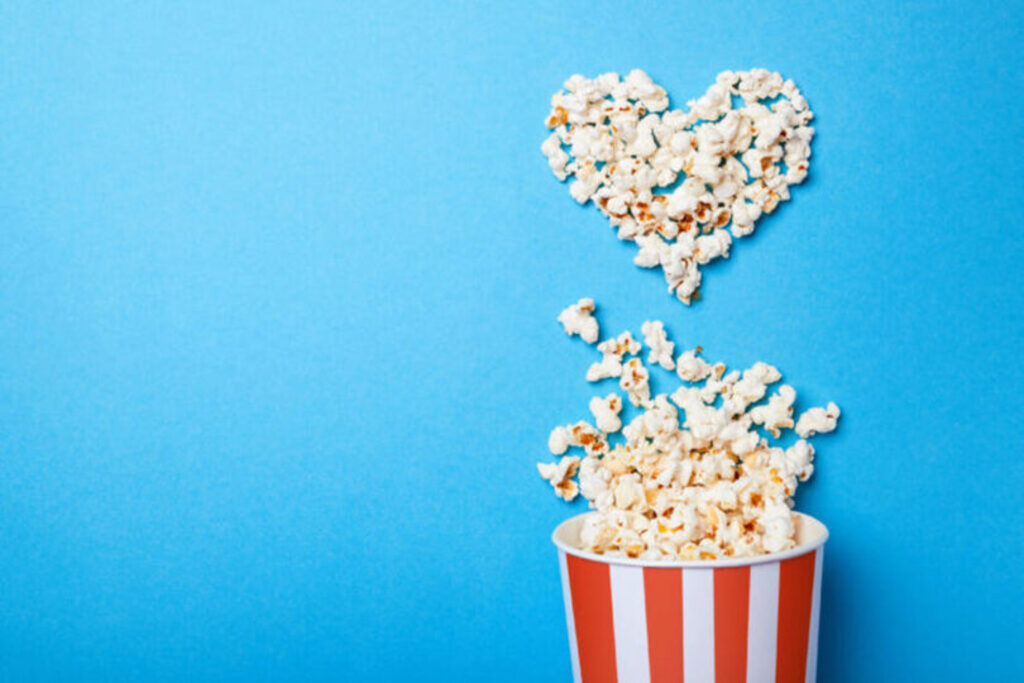 Popcorn Carton With Heart Made of Popcorn on Blue Background